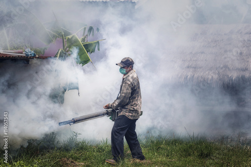 Asian man fogging mosquitoes
