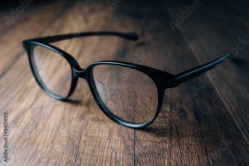 Black Vintage Eye Glasses on wooden background