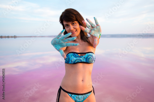 Pretty woman with holi colours in a colorful lake