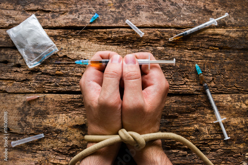 man holding syringe drug addiction