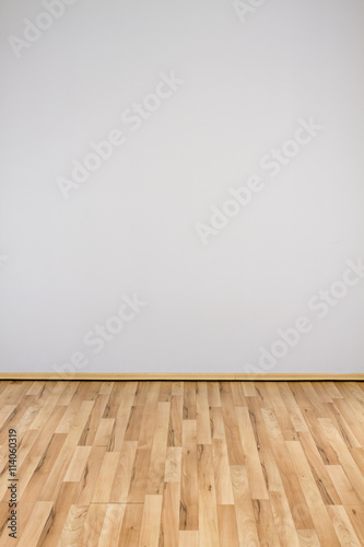 copyspace background with an empty white wall with a hardwood wooden floor © ctvvelve