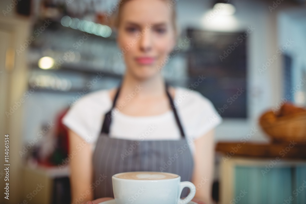 Close-up of barista offering coffee at cafe Close-up of barista offering coffee at cafe