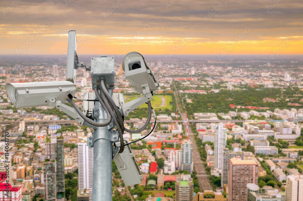 CCTV or surveillance camera recording important events and a guard house and property with the sunrise in the morning at the big city background. CCTV or surveillance camera recording important events and a guard house and property with the sunrise in the morning at the big city background.