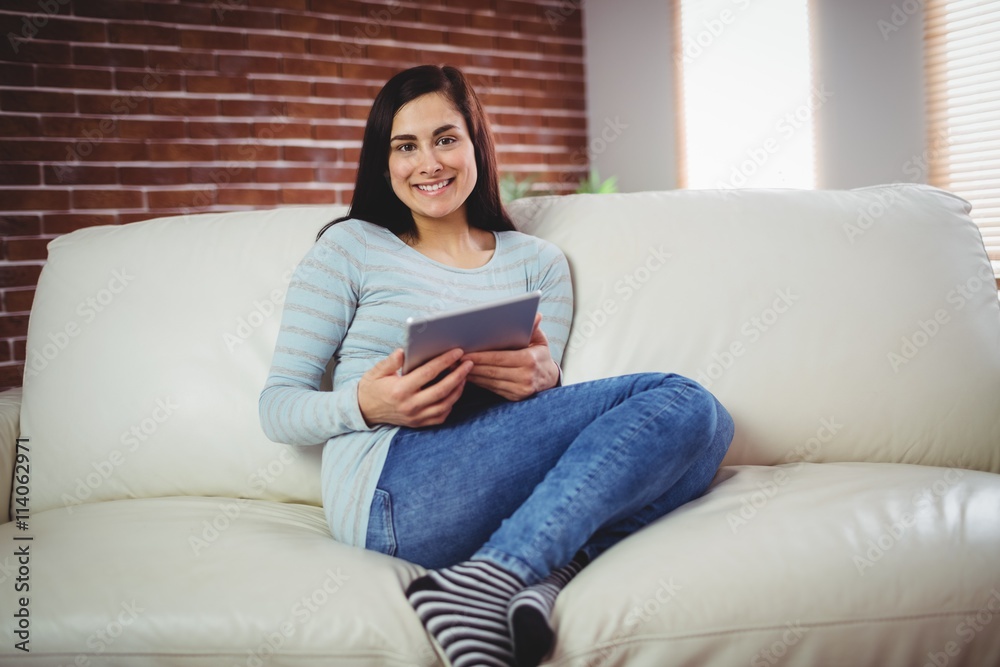 Portrait of smiling woman on sofa at home Portrait of smiling woman on sofa at home