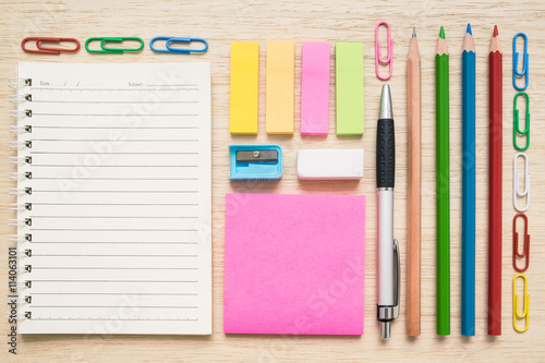 Top view of stationery tools and equipment on wooden background