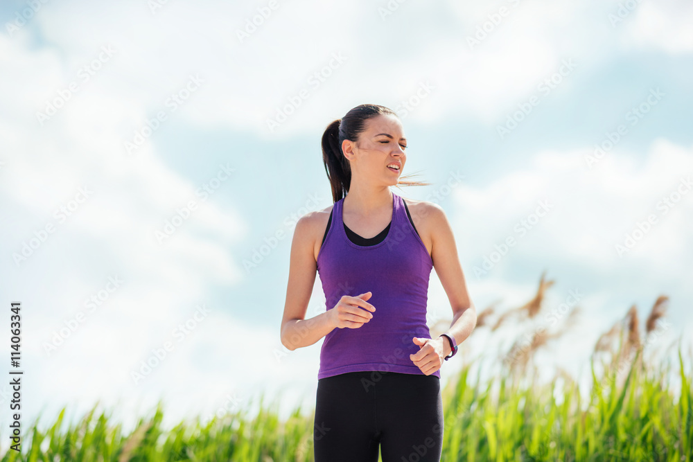Running beautiful young woman on nature background. Hard workout and exercises. Sport Running beautiful young woman on nature background. Hard workout and exercises. Sport