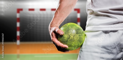 Tableau sur toile Composite image of sportsman holding a ball