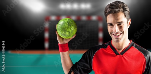 Composite image of portrait of happy athlete man holding a ball  © vectorfusionart
