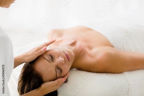 Cropped image of masseur giving massage to woman