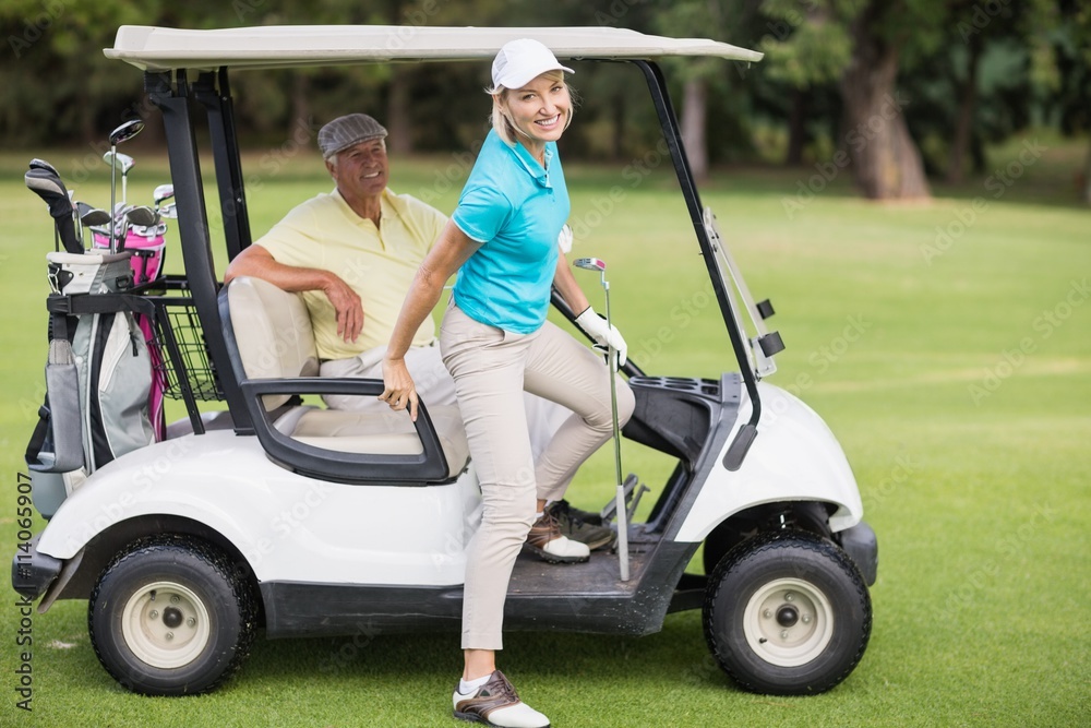 Portrait of smiling golfer couple Portrait of smiling golfer couple