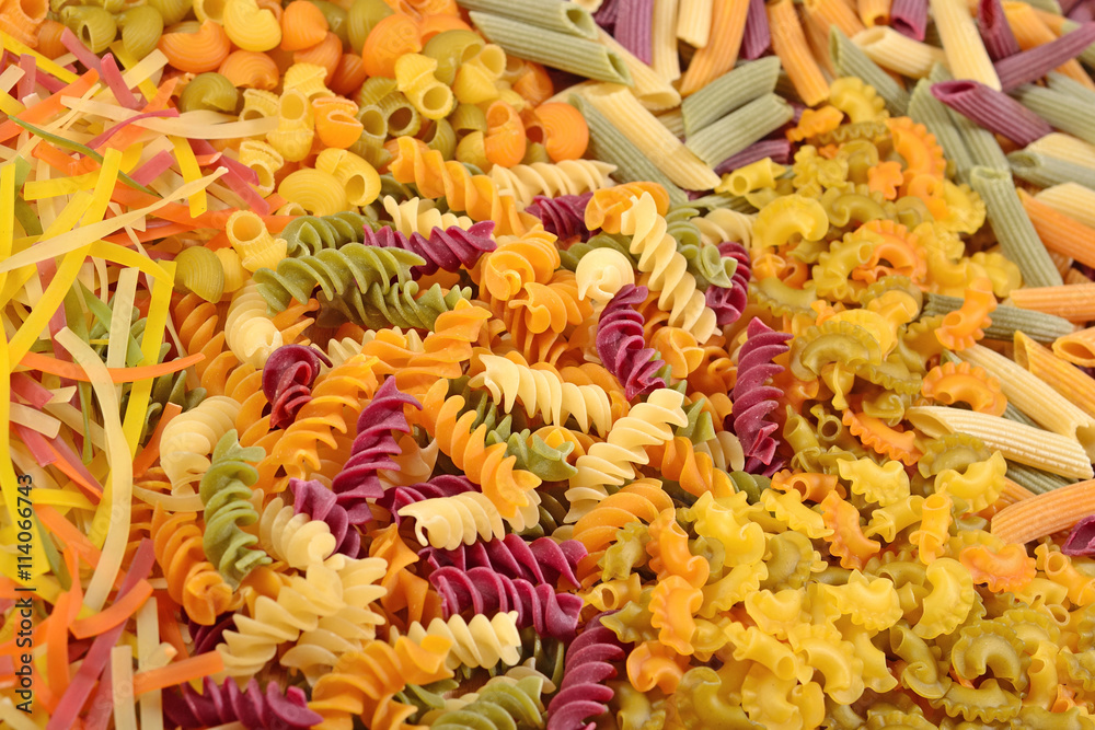 Fototapeta premium Assortment of colored uncooked Italian pasta close up