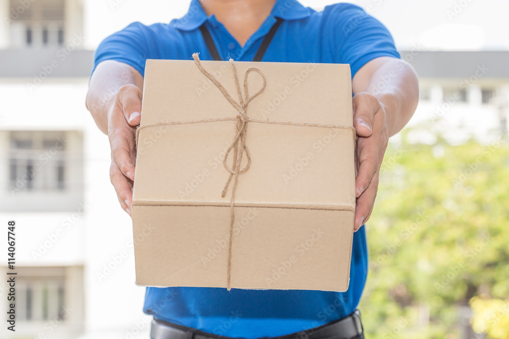 Delivery man holding a parcel box. Delivery service concept Delivery man holding a parcel box. Delivery service concept
