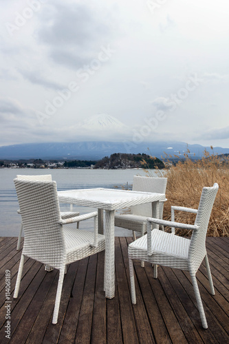 White dining table on wooden floor and Fuji mountain background © netohhayo