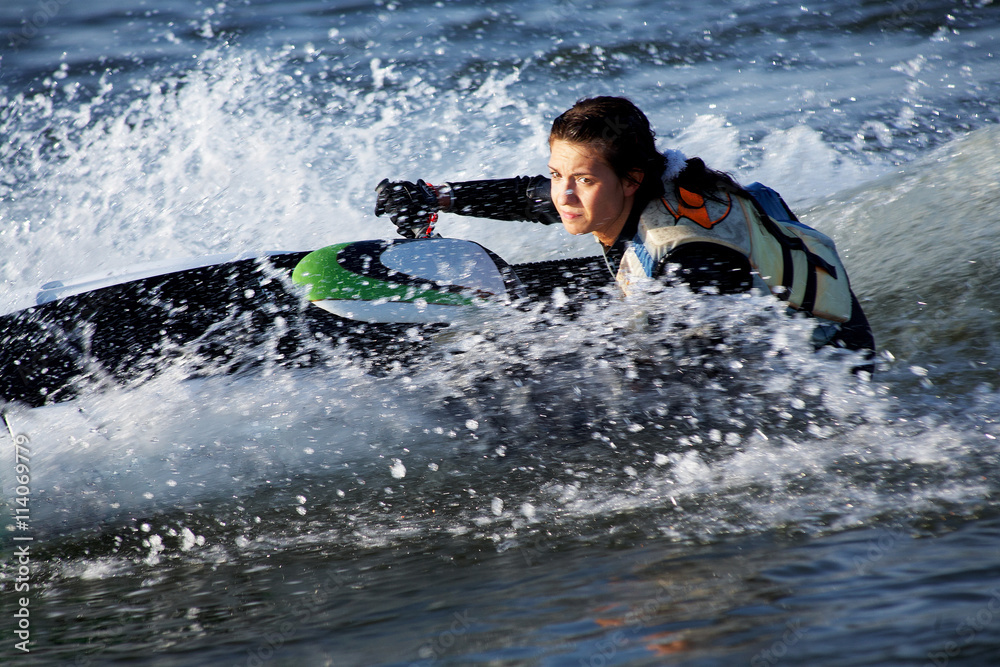 Naklejka premium .beautiful girl riding her jet skis.