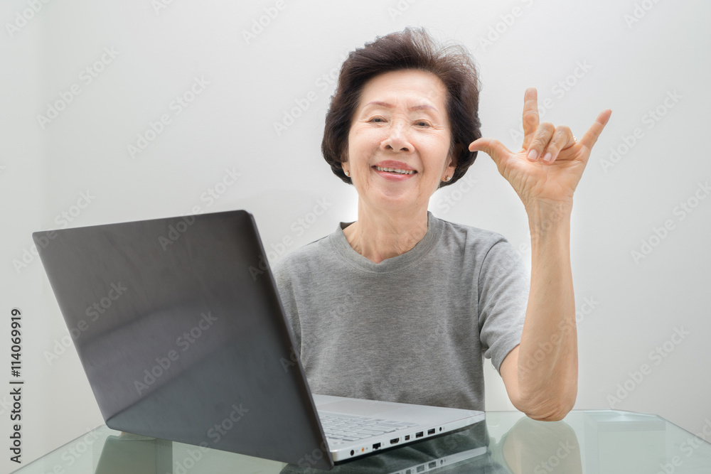 Elderly lady working with laptop ,working with laptop Elderly lady working with laptop ,working with laptop