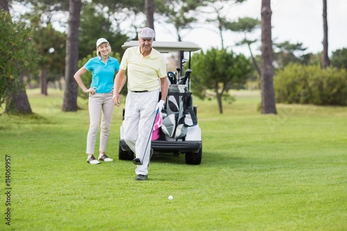 Couple standing at golf course 