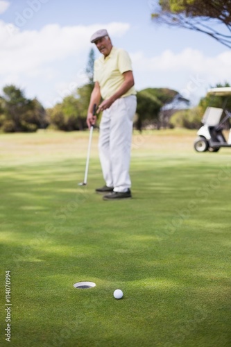Full length of mature man playing golf 