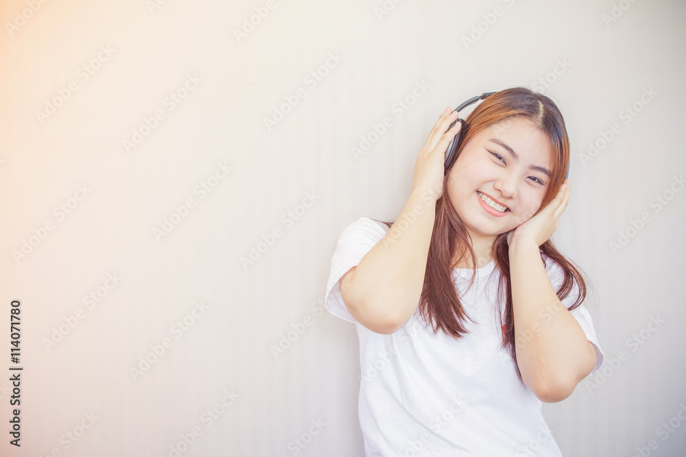 Fototapeta premium asian young woman enjoying with her music listening