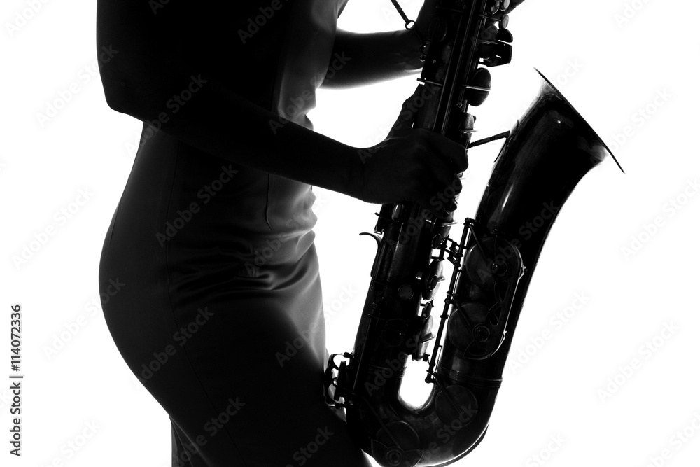 Obraz premium young woman playing the saxophone