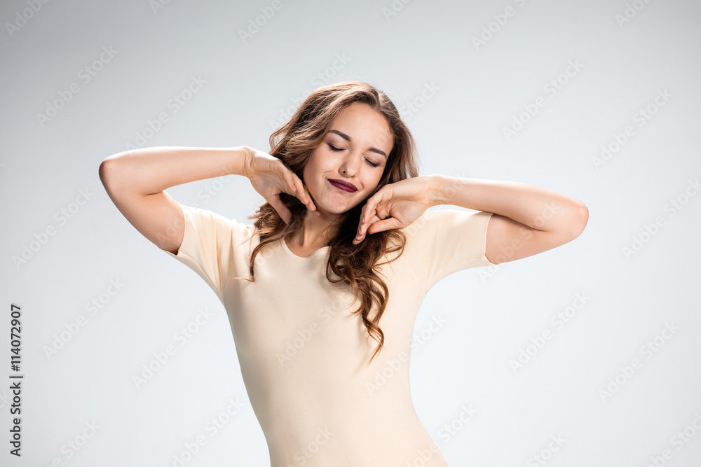 Fototapeta premium The happy thoughtful woman on gray background