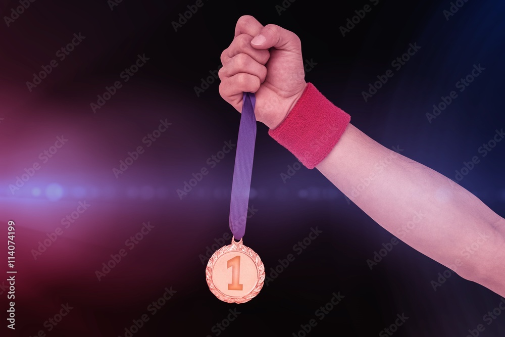 Athlete holding gold medal after victory Athlete holding gold medal after victory