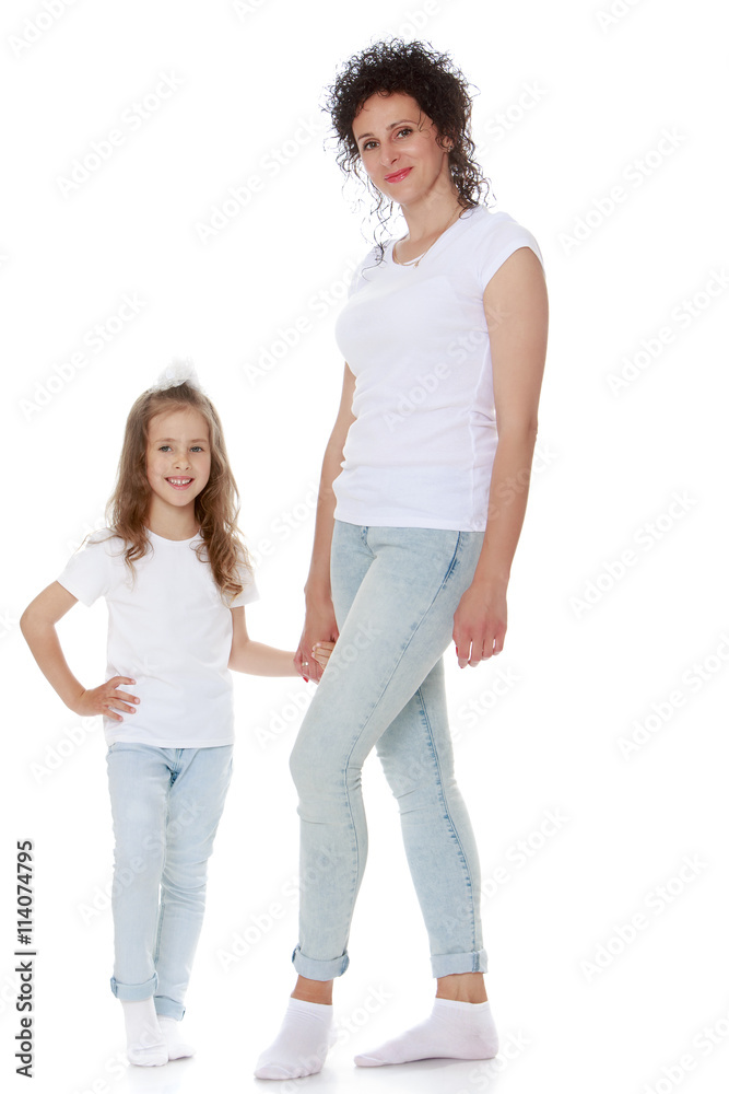 Stylish mom and daughter in matching jeans and white shirts - Isolated on white background Stylish mom and daughter in matching jeans and white shirts - Isolated on white background