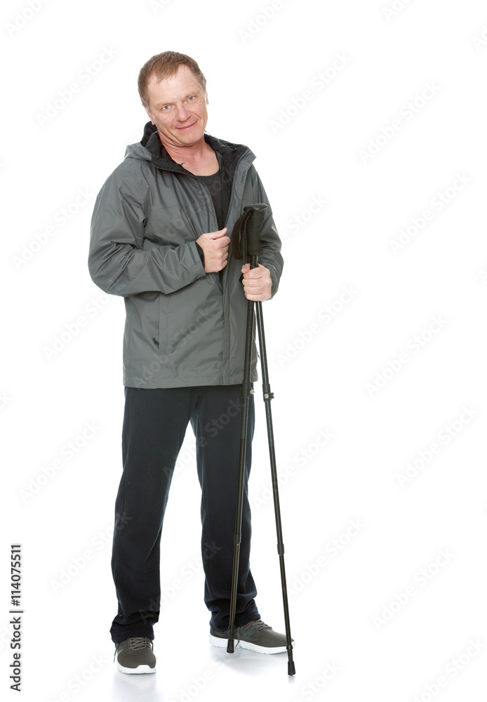 A 50 year old man in a track suit relies on sticks for Nordic