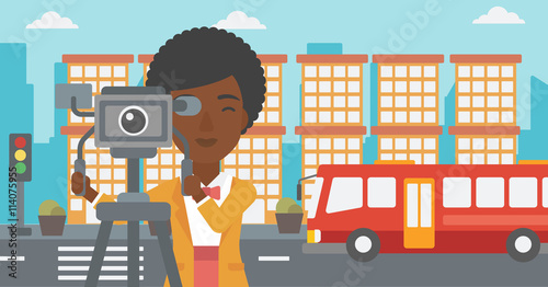 Camerawoman with movie camera on a tripod.