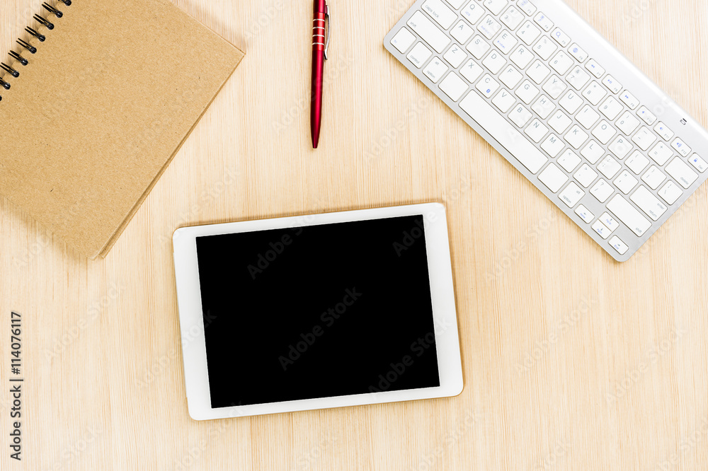 Top view office table with pen and notebook and tablet or smartphone