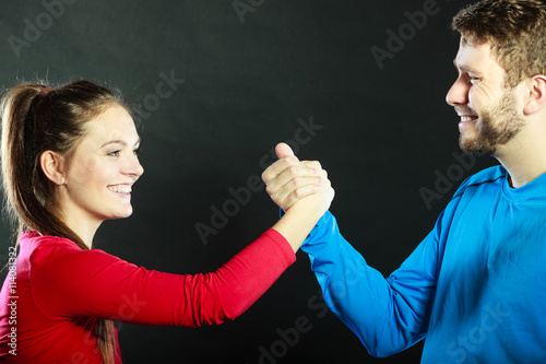 Friends man and woman clasping shaking hands.