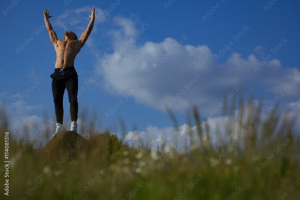 Sexy muscular man on sky background Sexy muscular man on sky background