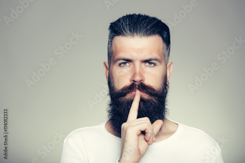 Bearded man with hush gesture