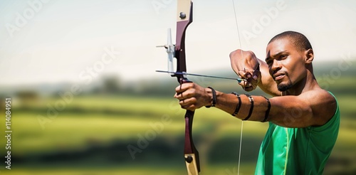 Composite image of close up view of man practicing archery 