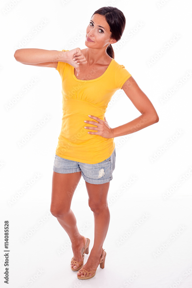 Disappointed brunette gesturing a thumbs down Disappointed brunette gesturing a thumbs down