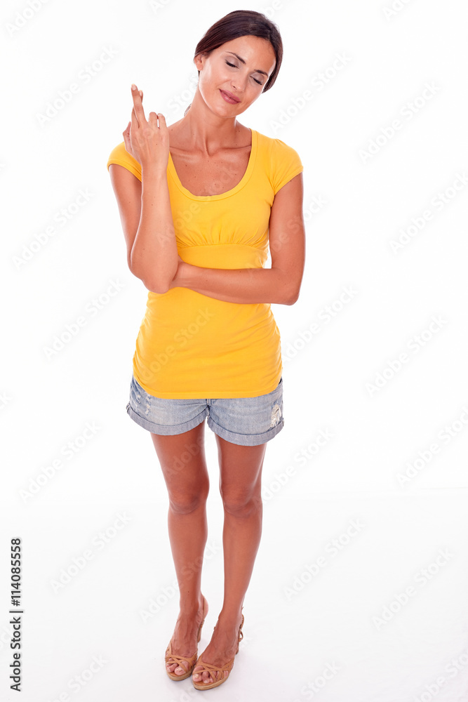 Wishing brunette woman with fingers crossed Wishing brunette woman with fingers crossed