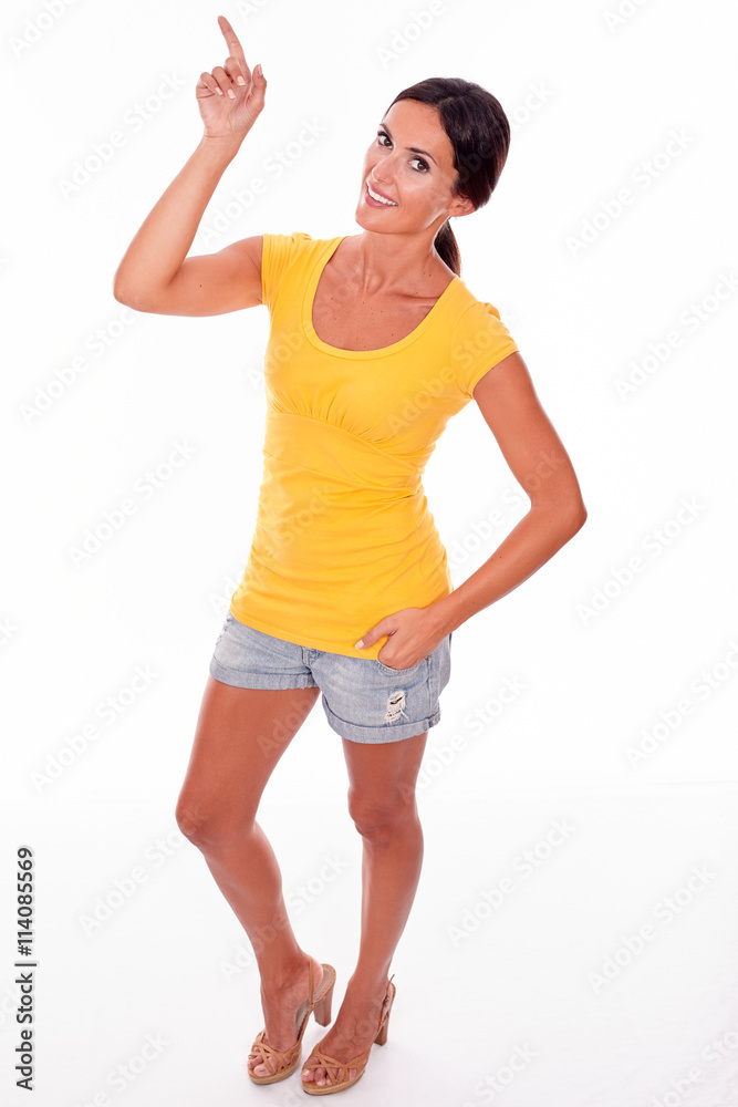 Smiling caucasian adult woman pointing upward Smiling caucasian adult woman pointing upward