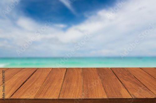 Wood table top on tropical ocean sky background. For display products