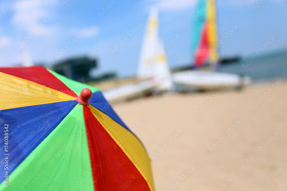 Top of a Colorful Beach Umbrella against the Sky and boat and se
