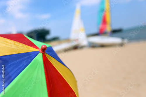 Top of a Colorful Beach Umbrella against the Sky and boat and se © Saklakova