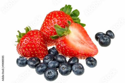 Pile of berries. Strawberries and blueberries on white background. An arrangement of strawberries and blueberries, isolated on white.