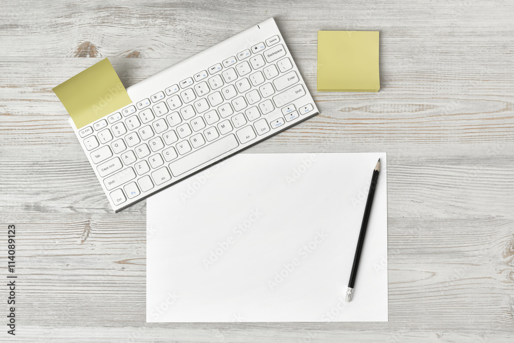 Office workplace with keyboard, pen and white blank paper Office workplace with keyboard, pen and white blank paper