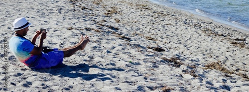 Canvas Print Man making selfie on his feet on the beach in Copenhagen