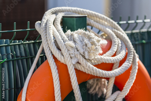 Detail of white rope and float in the lifeguard post of a swimming pool