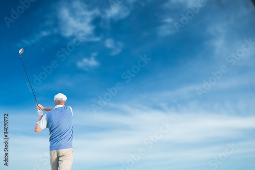 Rear view of man playing golf 