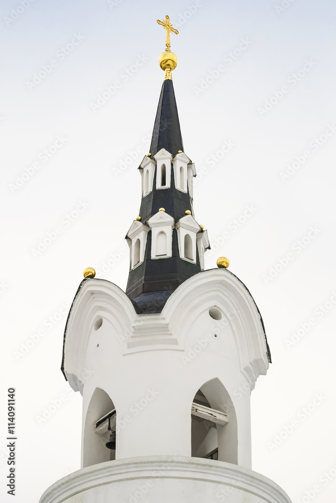 Bell tower and spire with a gilded cross of the Russian church was ...