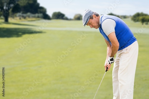 Focused man playing golf