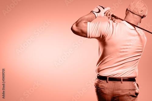Portrait of golf player taking a shot 