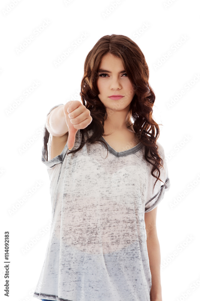 Unhappy young woman with thumbs down Unhappy young woman with thumbs down