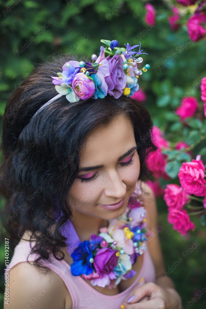 Naklejka premium Attractive young woman with blue flowers crown