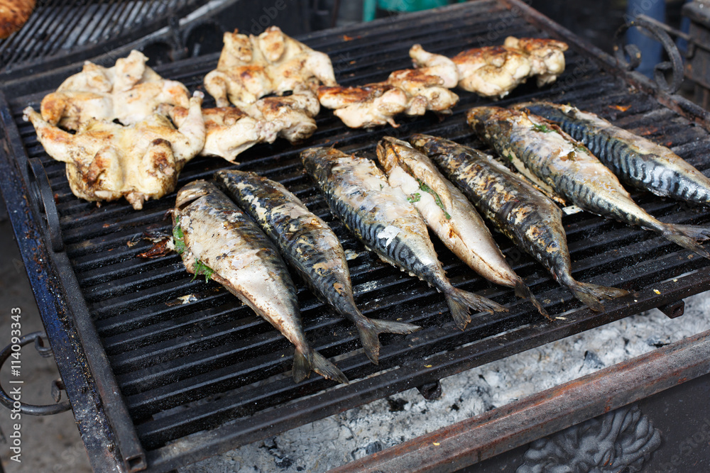Fish mackerel and chicken tabaka grilled at bbq Fish mackerel and chicken tabaka grilled at bbq